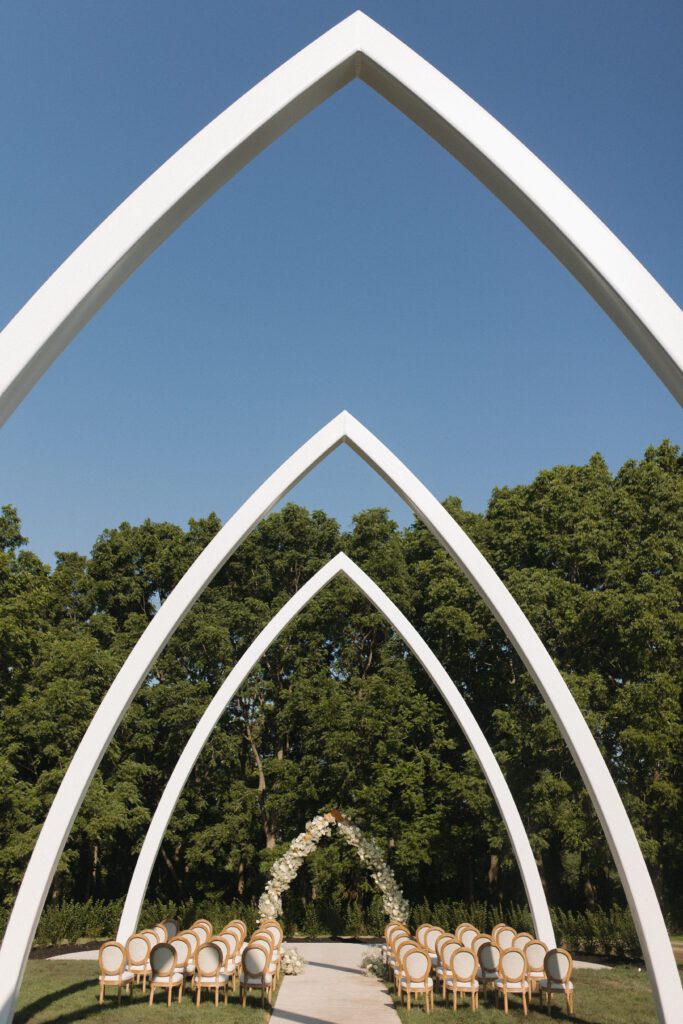 The Wells Estate grand ceremony arches in Avon, New York, surrounded by open fields and natural light