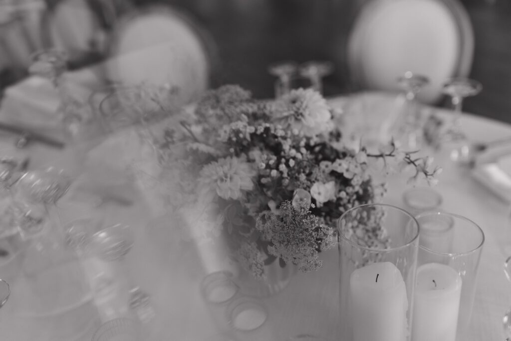 Elegant barn reception space at The Wells Estate in Avon, New York, featuring tall ceilings, soft candlelight, and refined decor