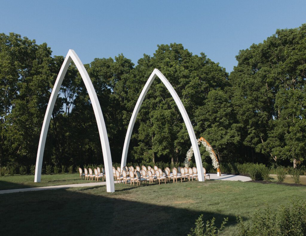 The Wells Estate grand ceremony arches in Avon, New York, surrounded by open fields and natural light